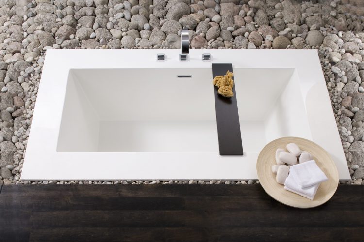 Drop in bathtubs with white finish, thick edges, and dark wood bridge