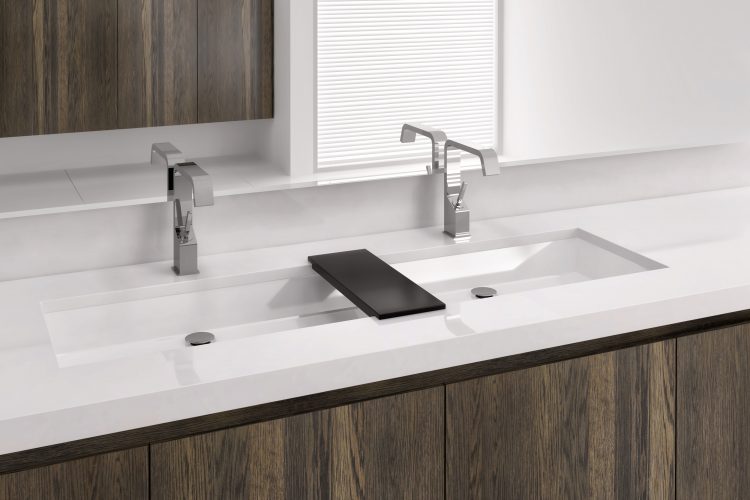 Undermount sinks by Wetstyle. Large rectangular sink with double faucets and wood bridge between them.