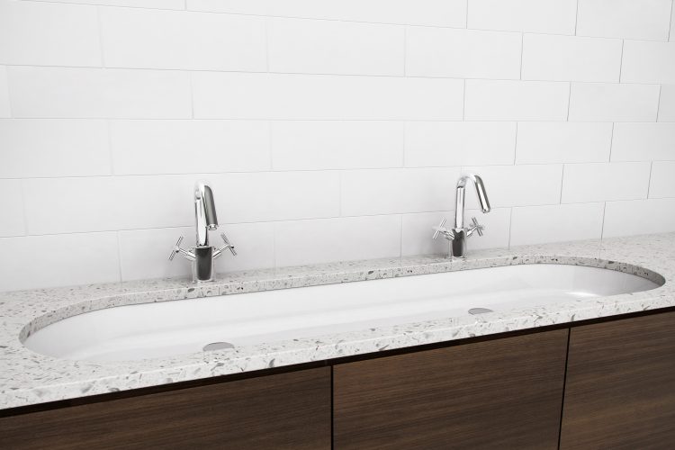 Undermount sinks by Wetstyle. Large oval sink with double faucets.