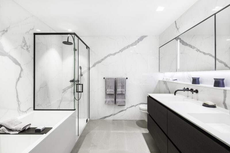 This image shows a bathtub and a shower in an luxury, elegant project. 