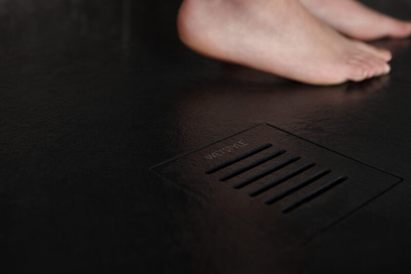 This image shows a shower base in black in a modern bathroom.