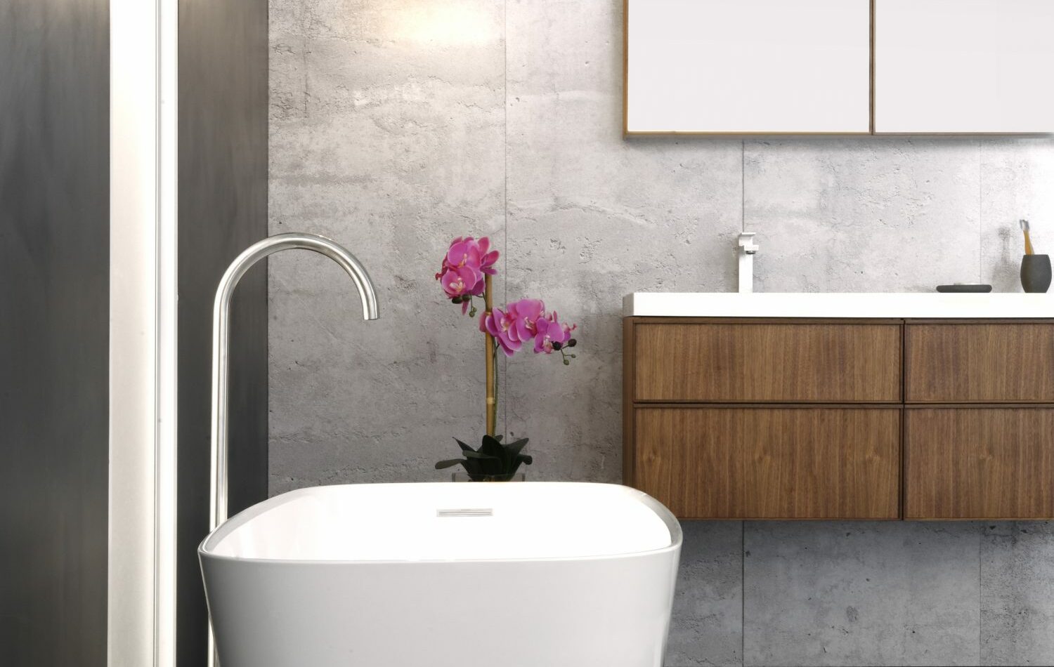 Freestanding bathtub with a white matte finish and wood vanity with white countertop